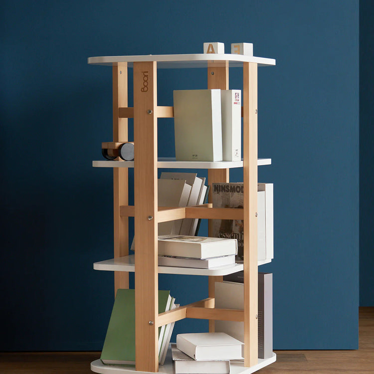 Wooden bookshelf with books against a blue wall