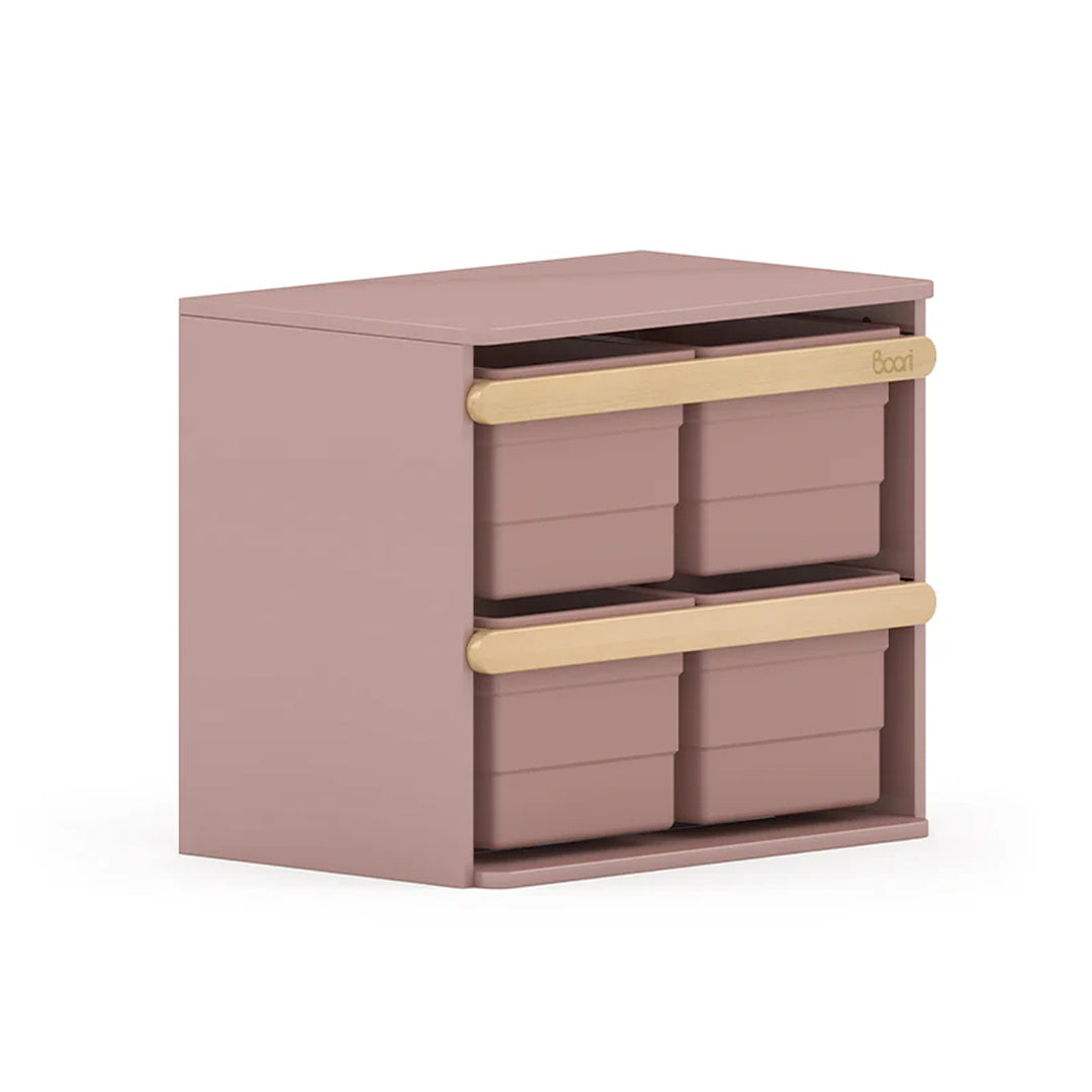 Pink storage unit with three drawers on a white background