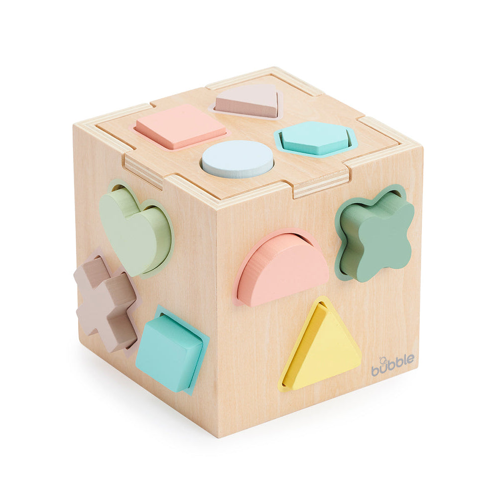 Wooden shape sorting cube with pastel-colored shapes on a white background
