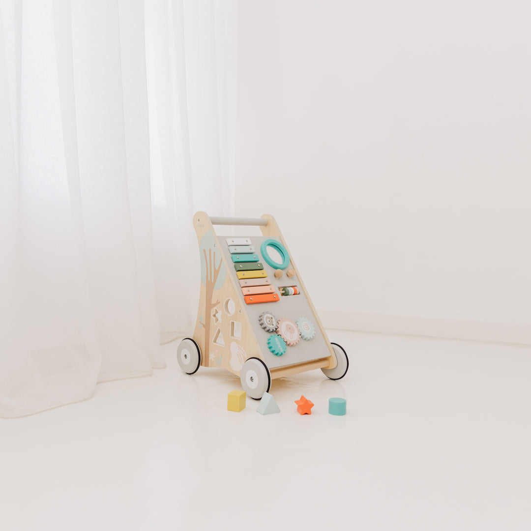 Wooden activity toy with colorful buttons and shapes on a white background