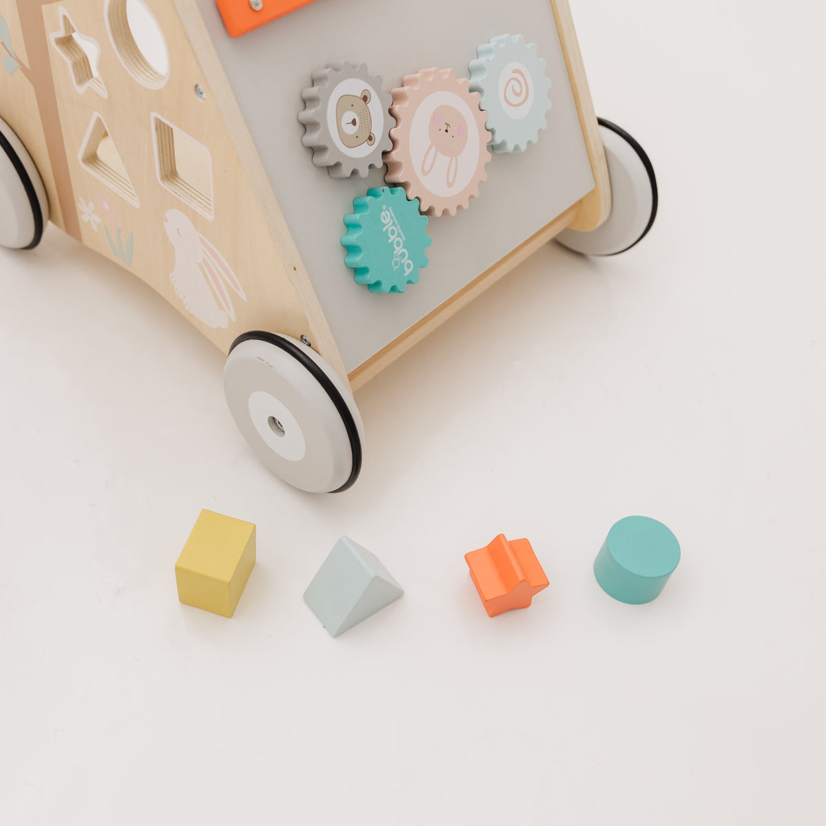 Wooden toy with gears and colorful blocks on a light background