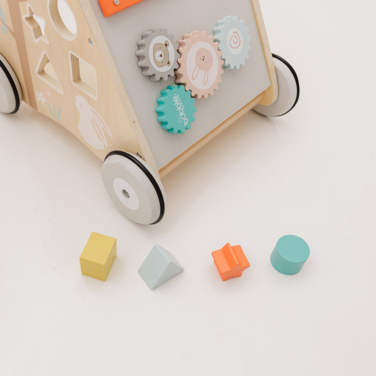 Wooden toy with gears and colorful blocks on a light background