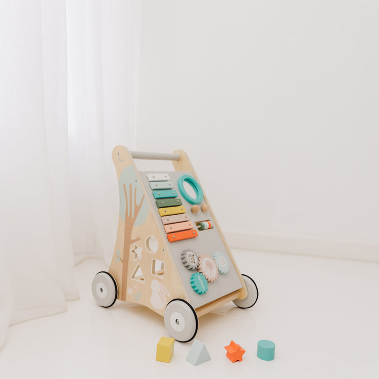 Wooden activity toy with colorful buttons and shapes on a white background