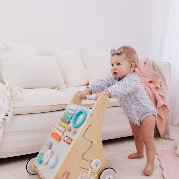 Baby playing with a wooden toy in a living room