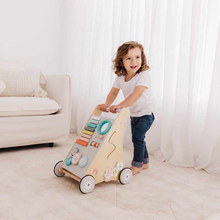 Child playing with a wooden toy in a bright room