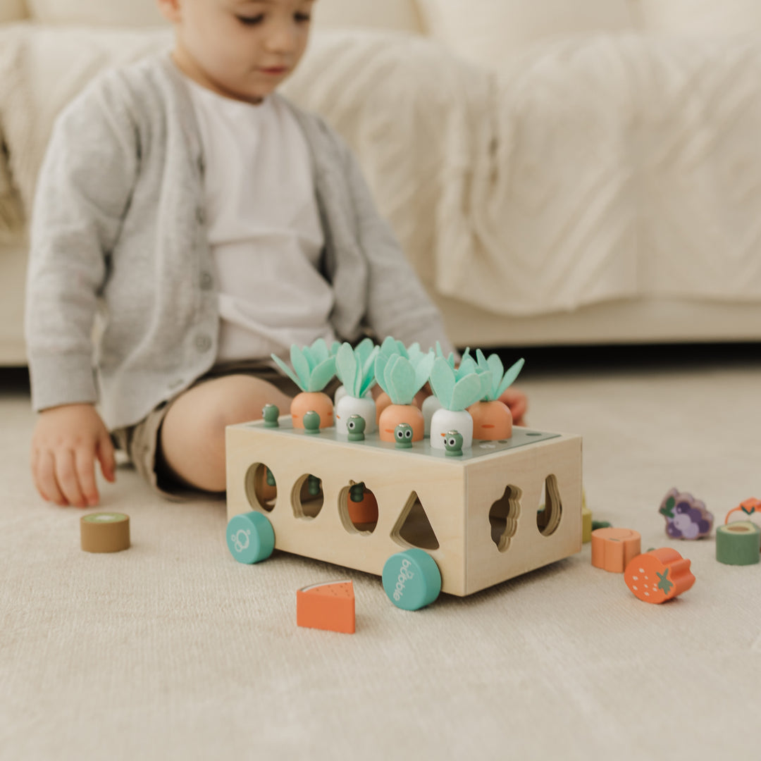 Child playing with a wooden toy on the floor