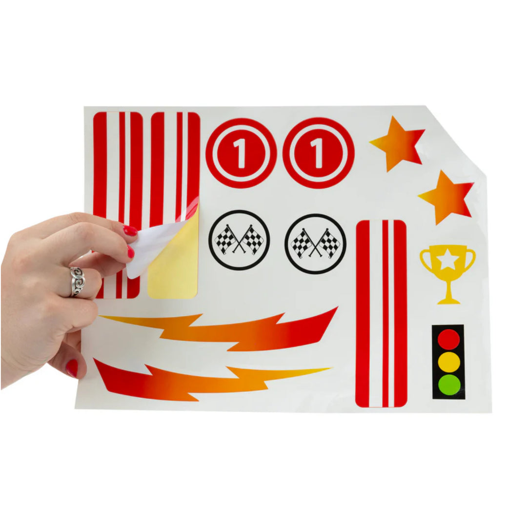 Sheet of racing-themed stickers held by a hand on a white background
