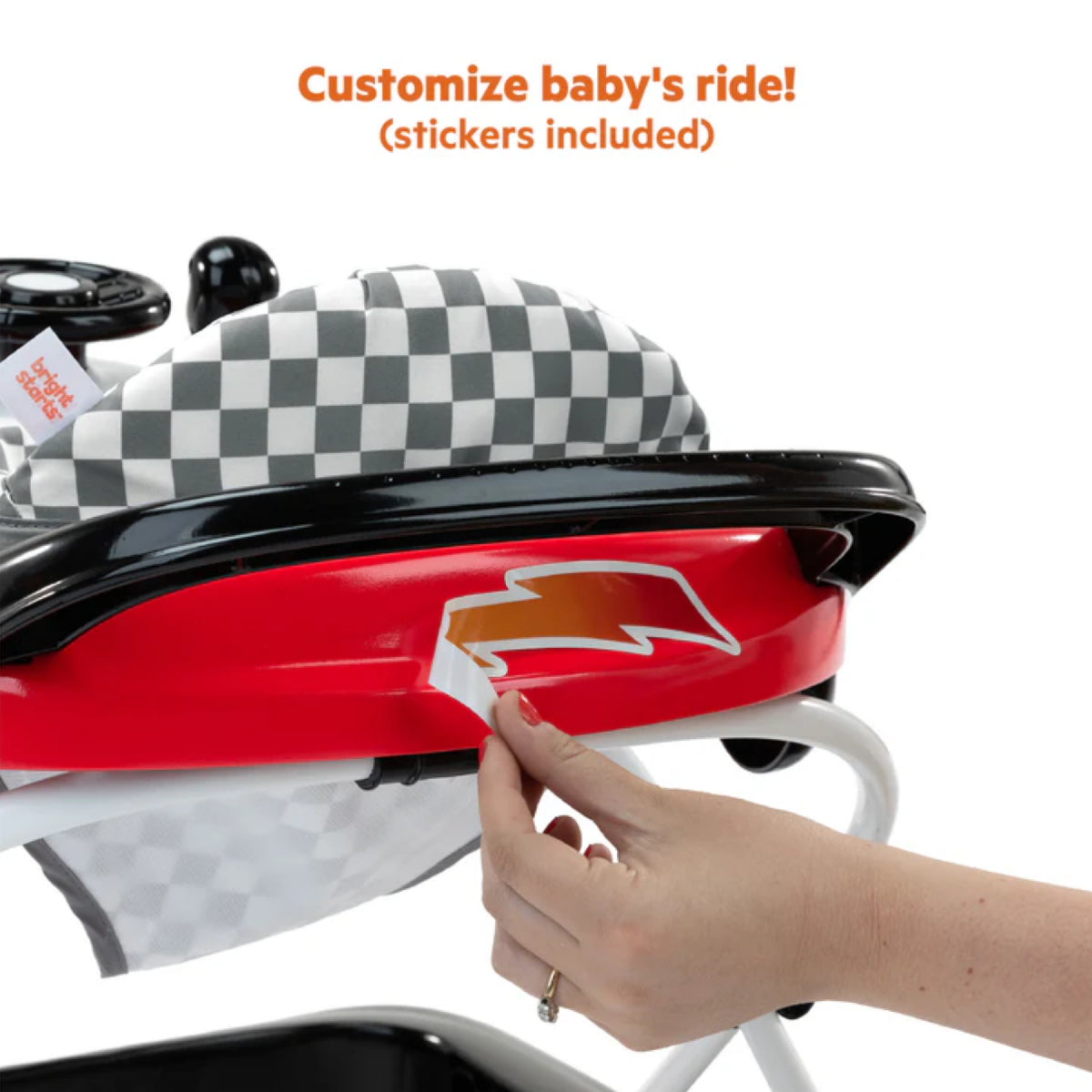 Baby walker with checkered pattern and red accents, hand placing a sticker on it.
