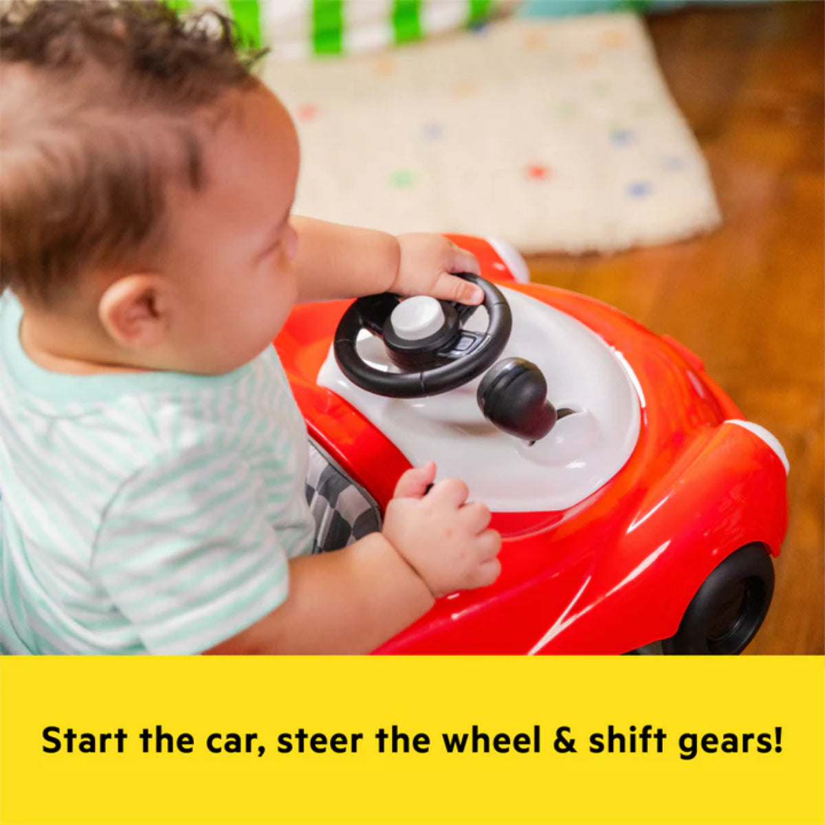 Child playing with a red toy car, focusing on steering wheel and gear shift.