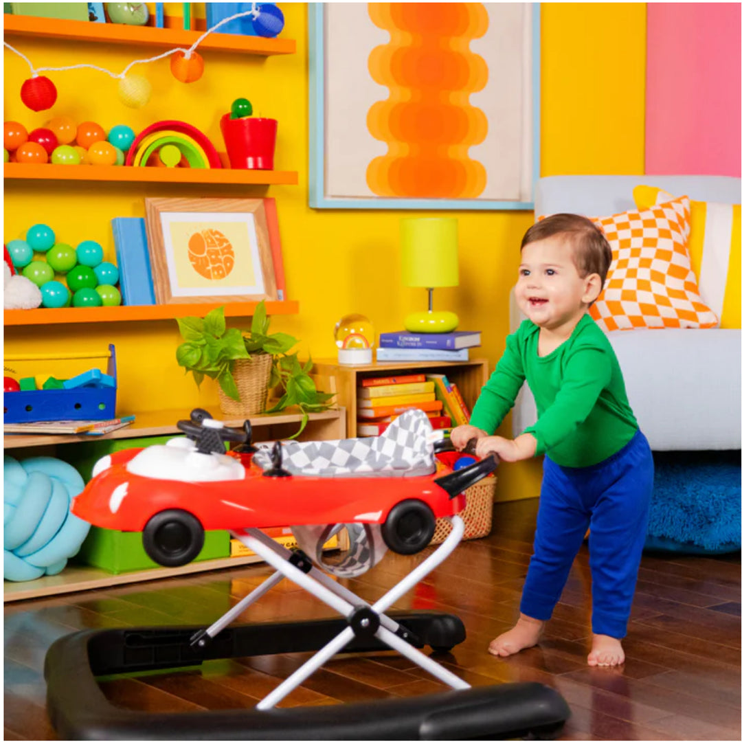Child playing with a toy car in a colorful room