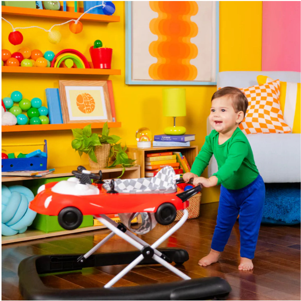 Child playing with a toy car in a colorful room
