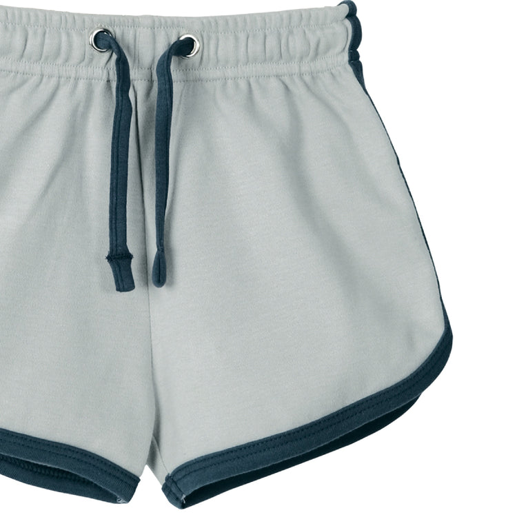 Light gray shorts with navy trim on a white background