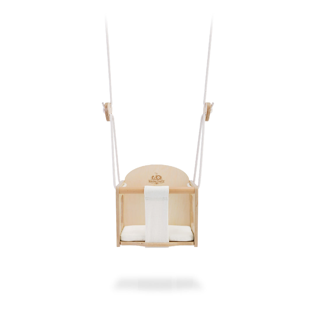Baby swing with a white cushion on a white background