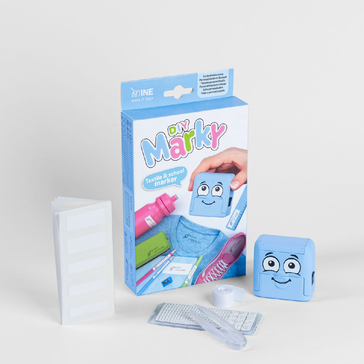 Blue children's toy packaging with a smiley face design on a white background