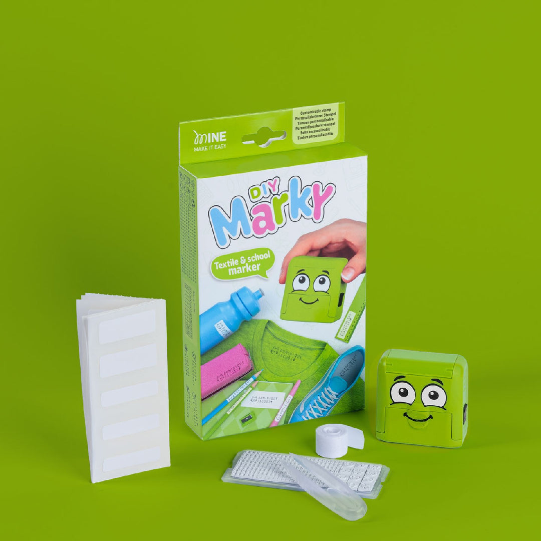 Green toy packaging with smiley face design on a green background