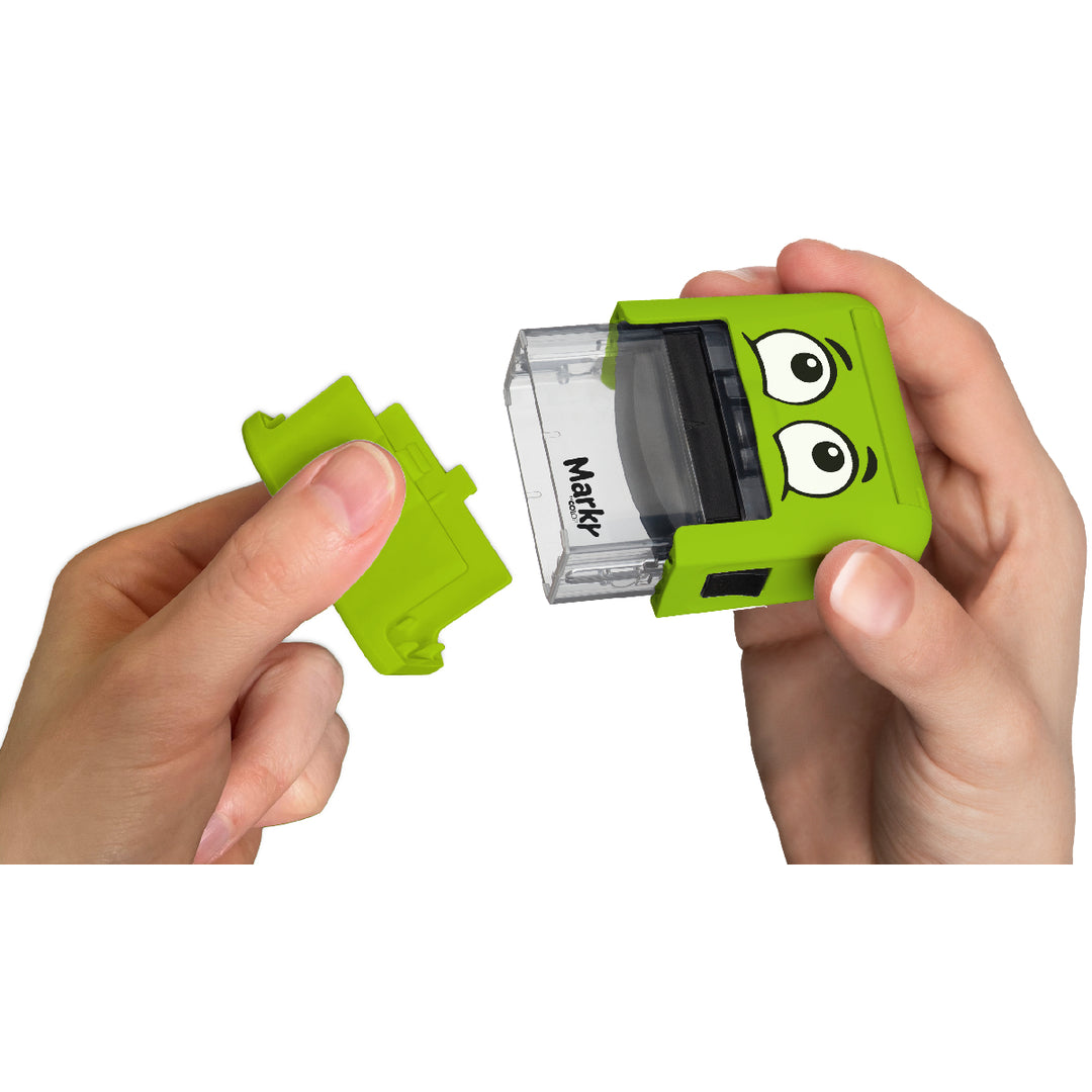 Green sharpener with cartoonish eyes held by hands on a white background