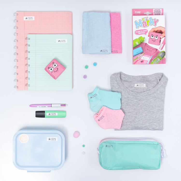 Collection of stationery items including notebooks, a pen, and a t-shirt on a white background