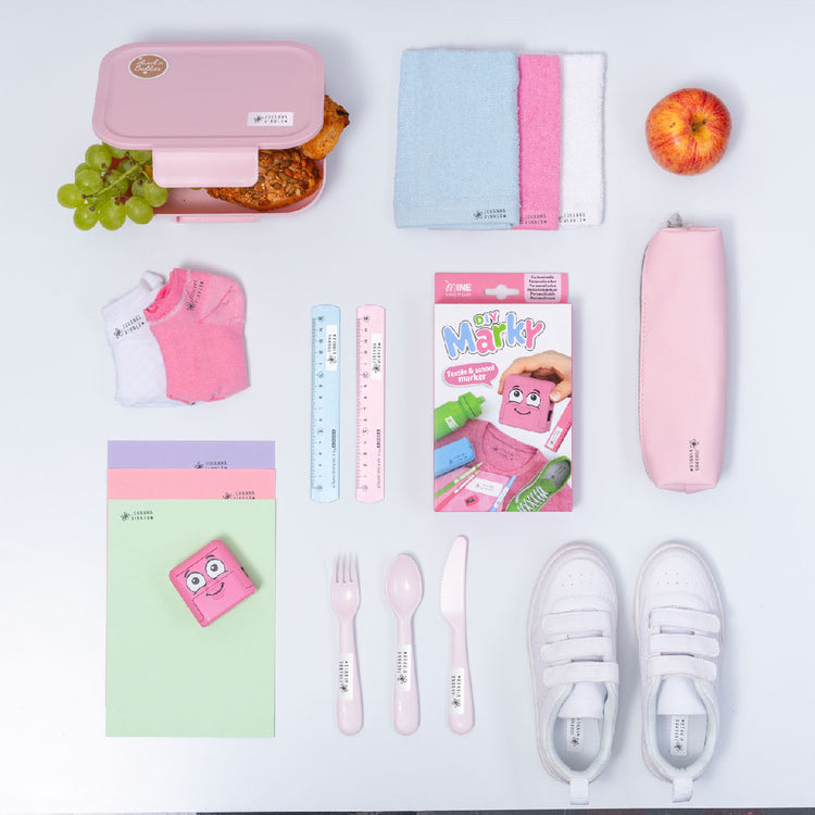 Collection of pink stationery and lunch items on a white background