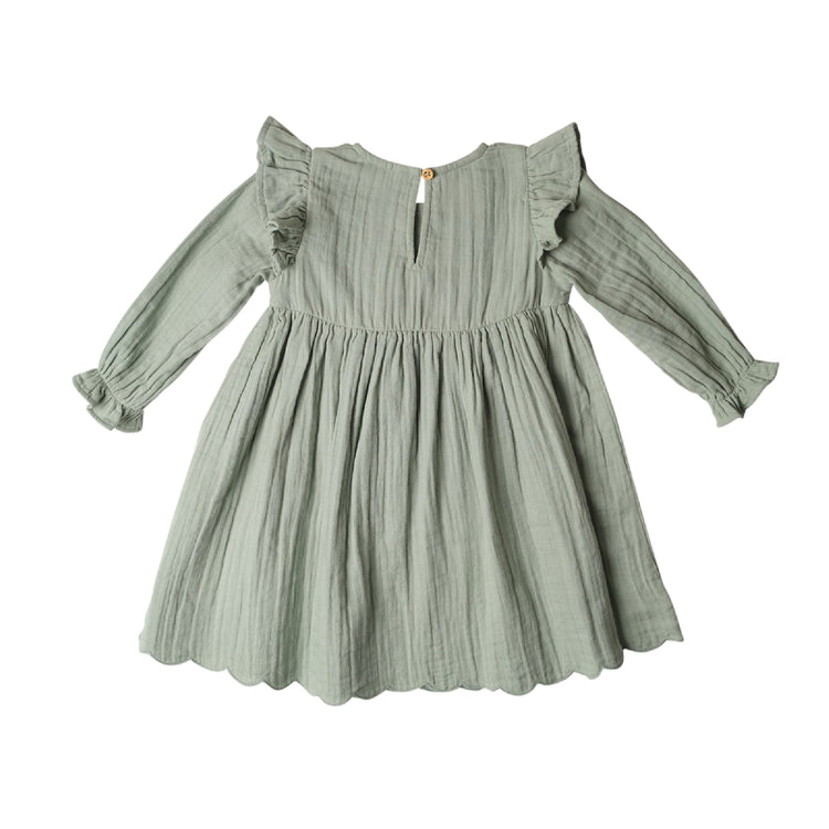 Green dress with ruffled sleeves on a white background