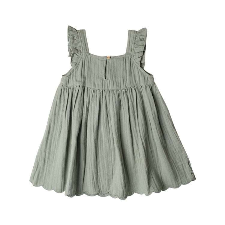 Green dress with ruffled straps on a white background