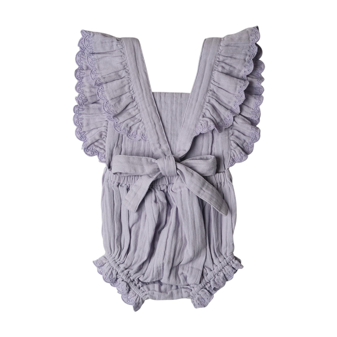Gray baby romper with ruffled details on a white background