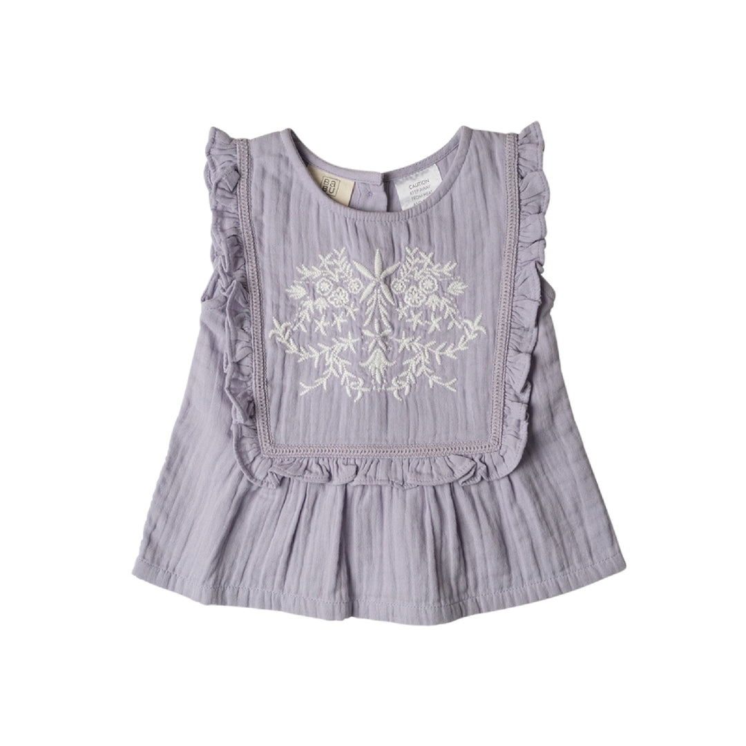 Light purple sleeveless top with ruffles and floral embroidery on a white background
