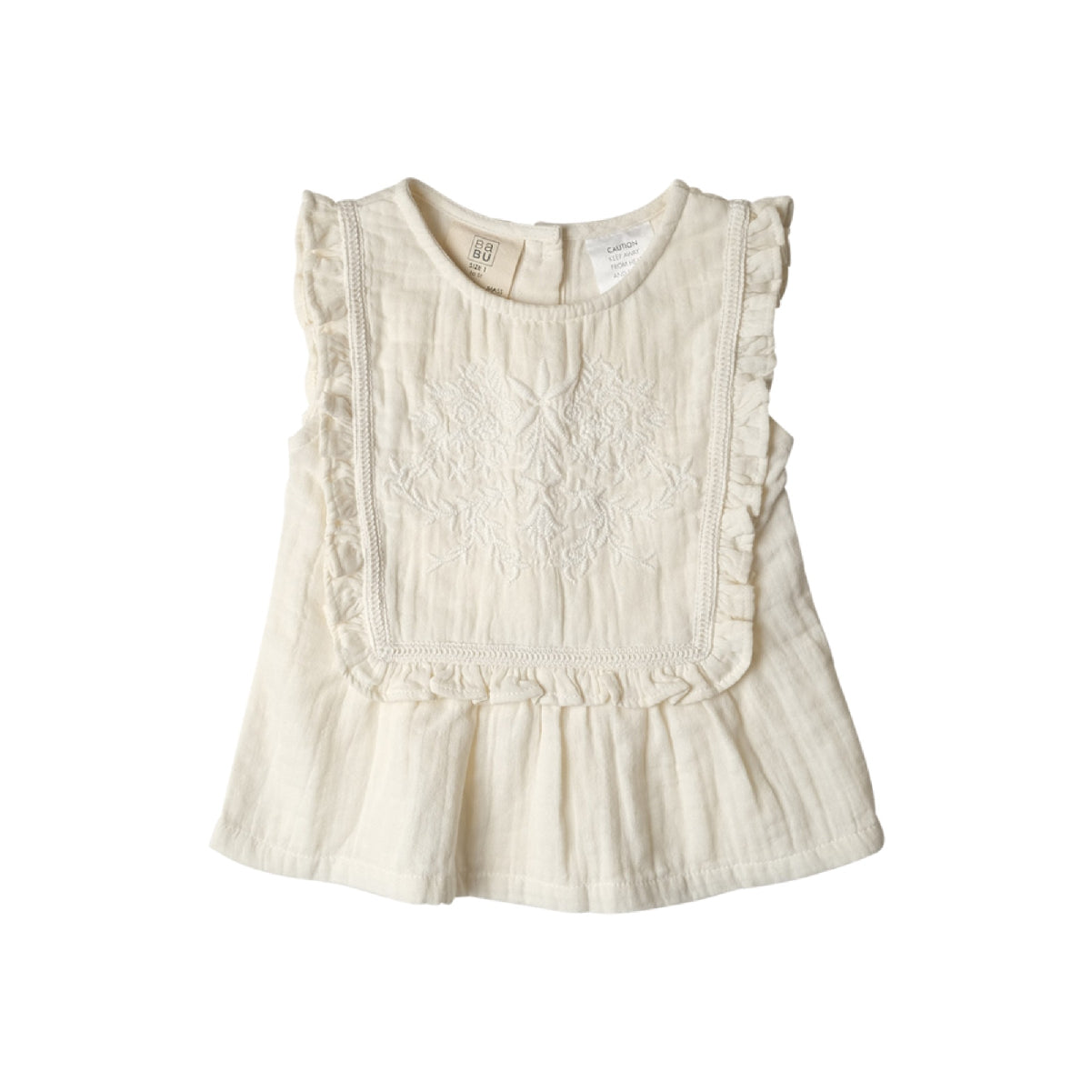 White sleeveless top with ruffled details on a white background