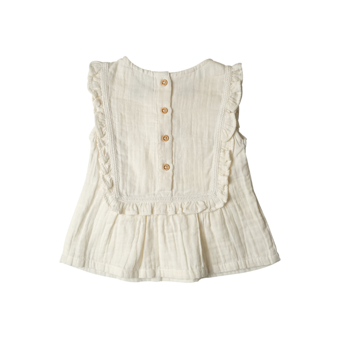 White sleeveless top with ruffled details and button front on a white background