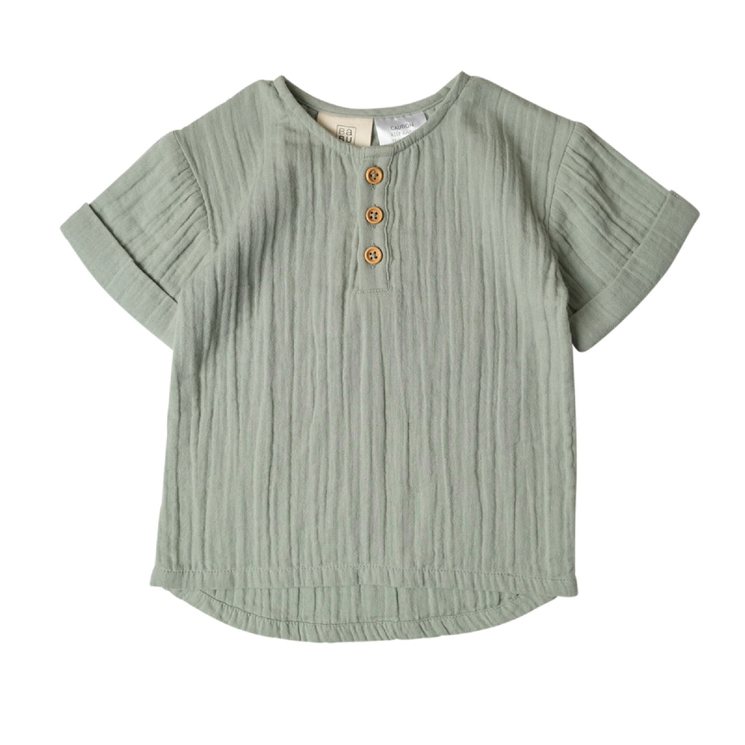 Green ribbed shirt with button details on a white background