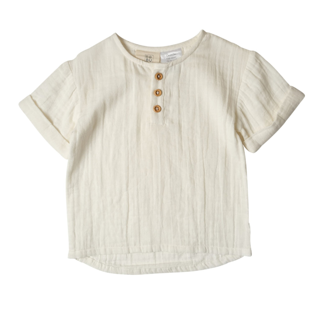 Beige short-sleeve shirt with button details on a white background
