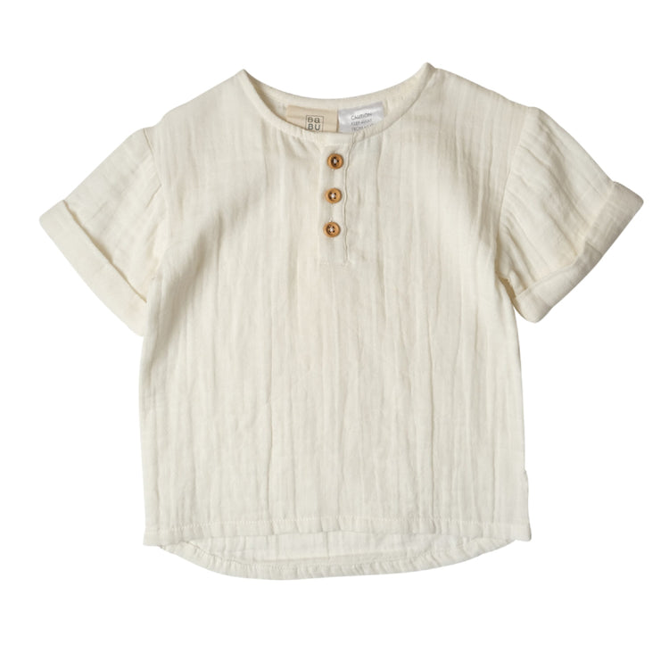Beige short-sleeve shirt with button details on a white background