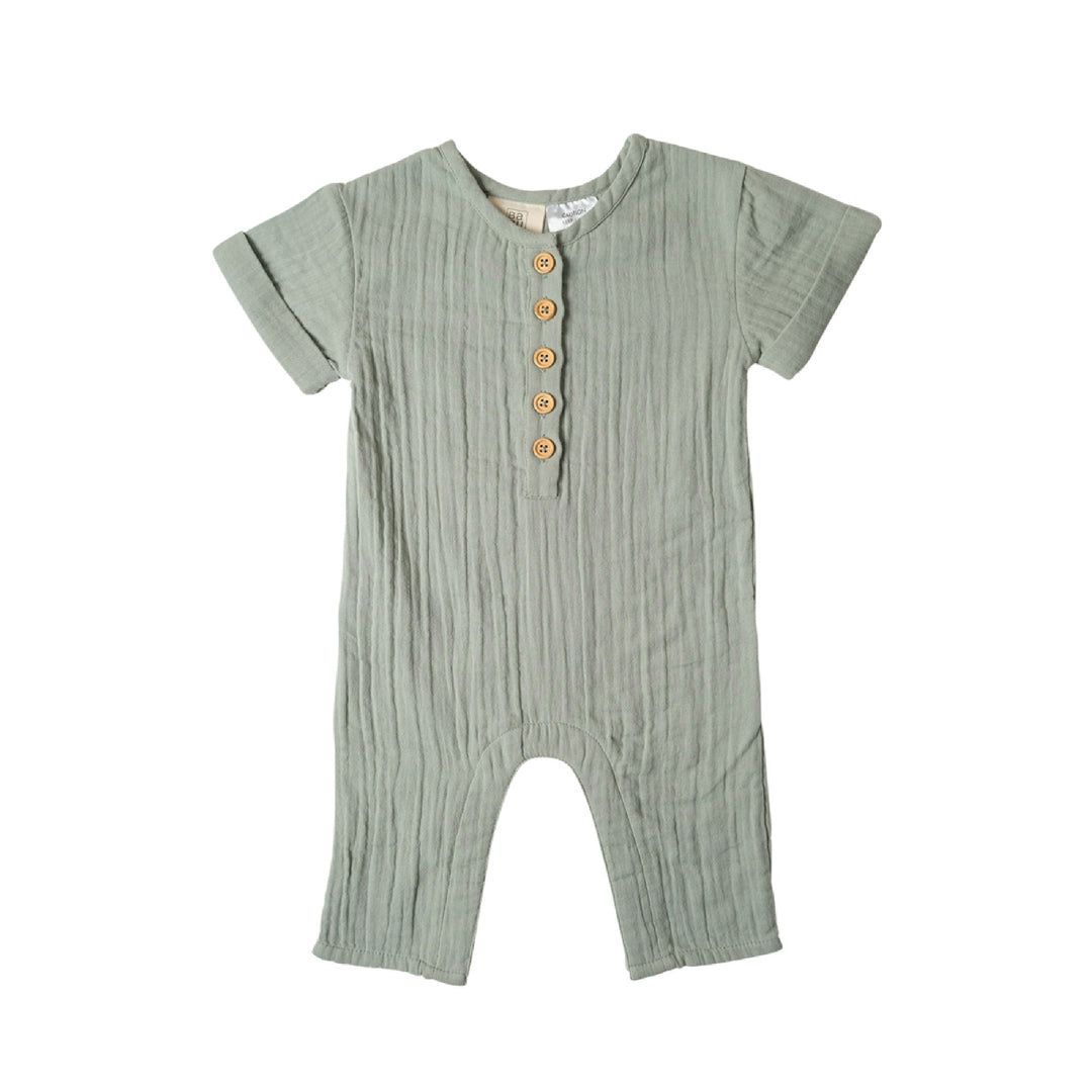 Green baby romper with button details on a white background