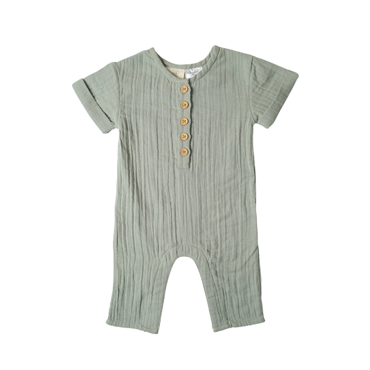 Green baby romper with button details on a white background