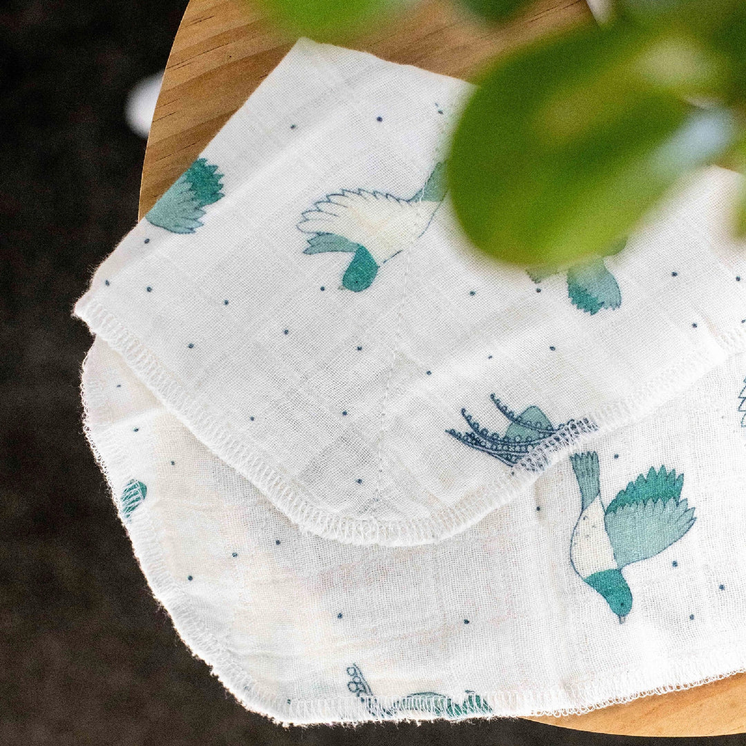 White fabric with blue bird designs on a wooden surface