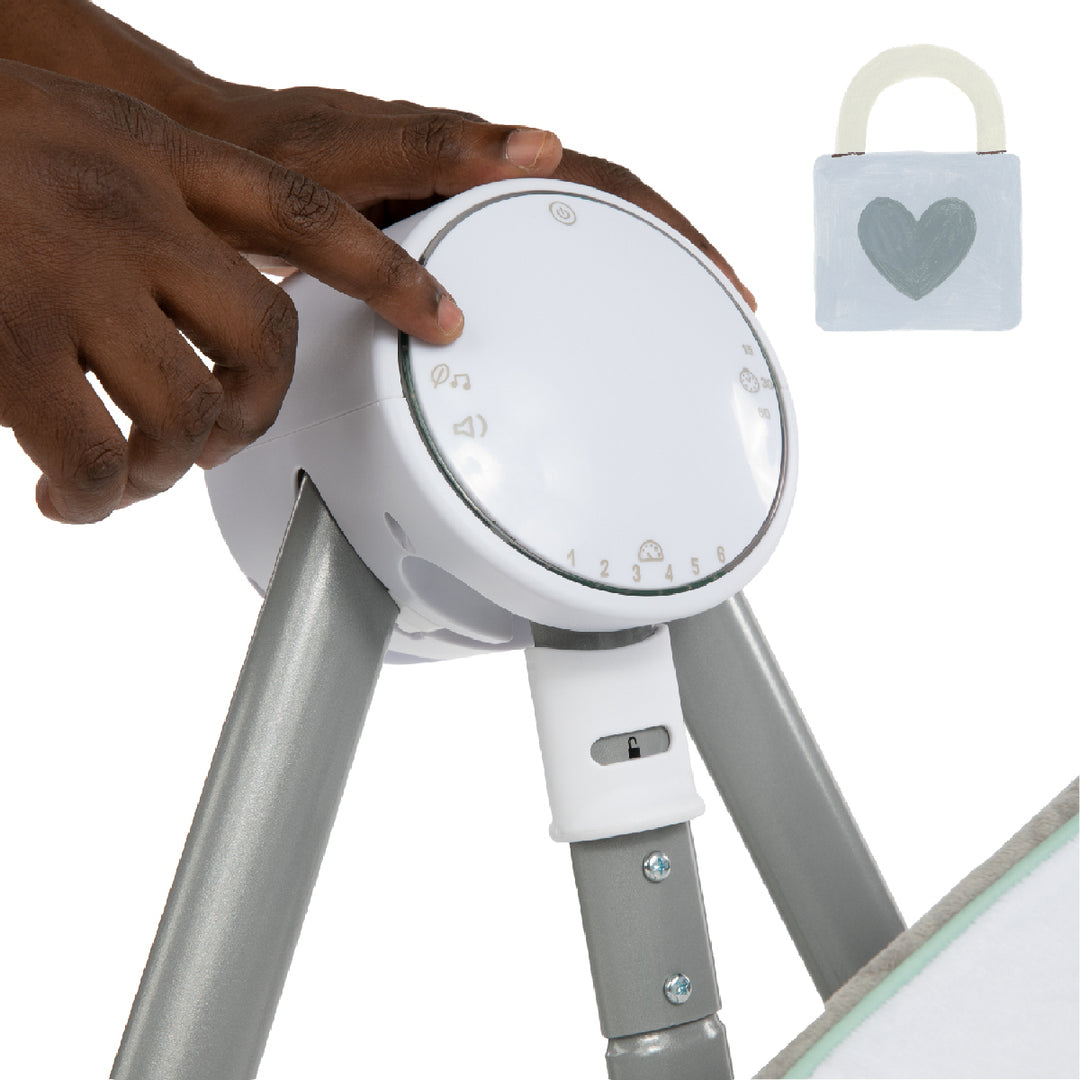 Hand adjusting a baby crib safety device with a heart-shaped lock icon on a white background