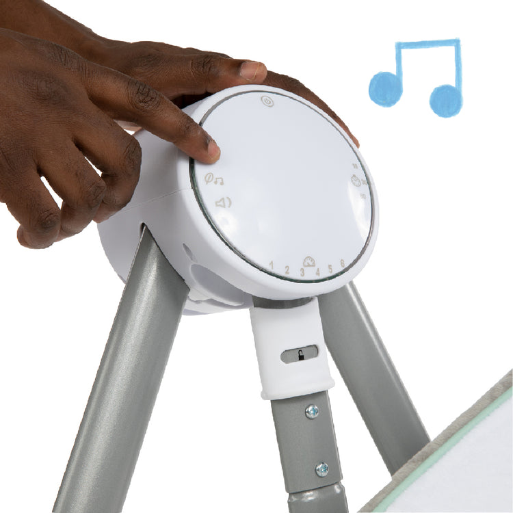 Hand adjusting a white baby monitor with musical notes icon on a white background