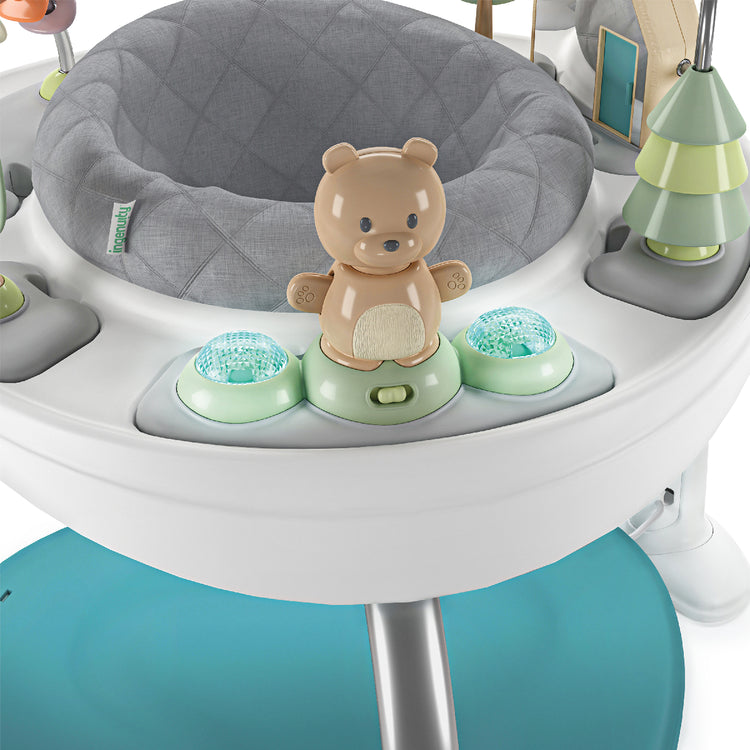 Baby activity center with gray cushion, teddy bear toy, and green buttons on a white background
