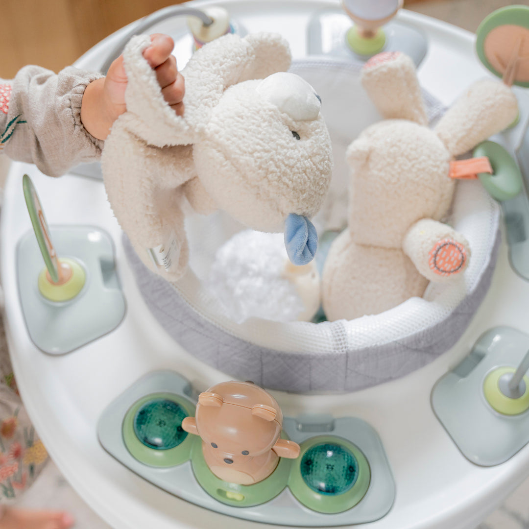 Baby toy with plush animals in a circular tray, likely in a baby walker.