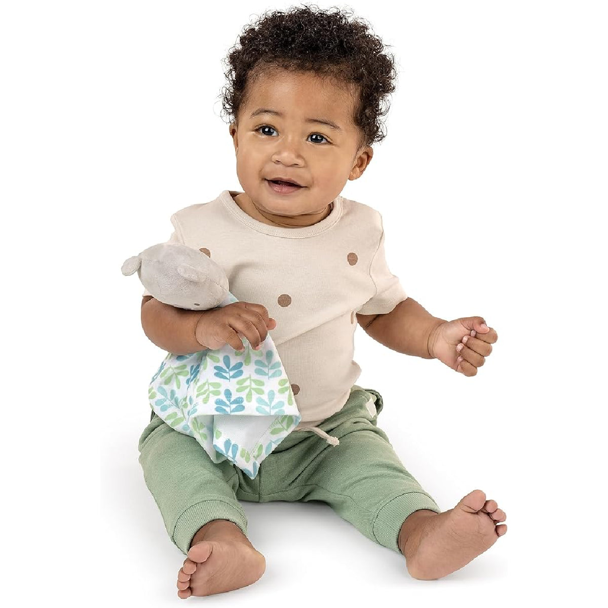 Baby holding a toy and bib on a white background
