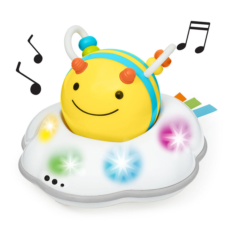 Colorful toy bee with lights and music notes on a white background