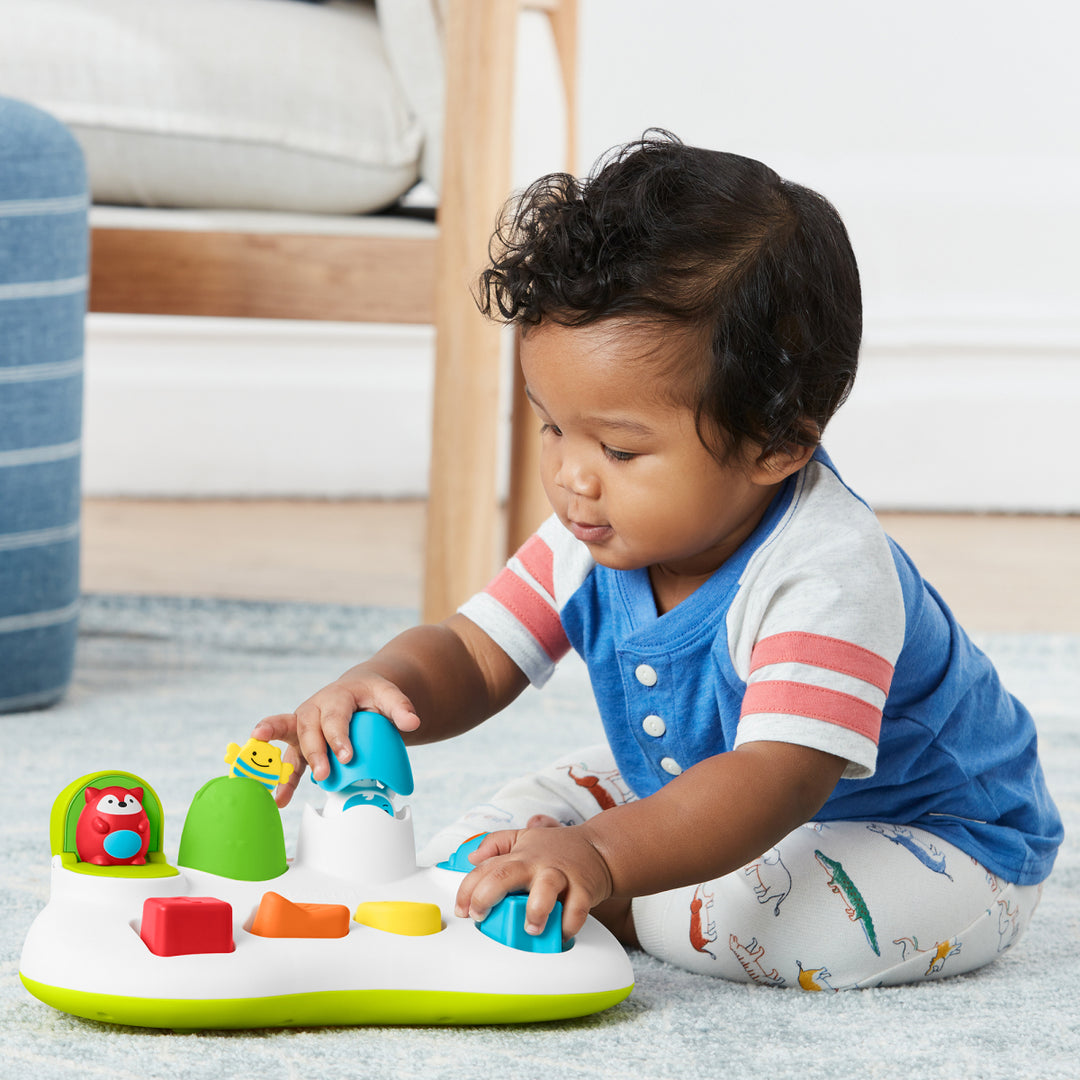 Child playing with a colorful toy on the floor