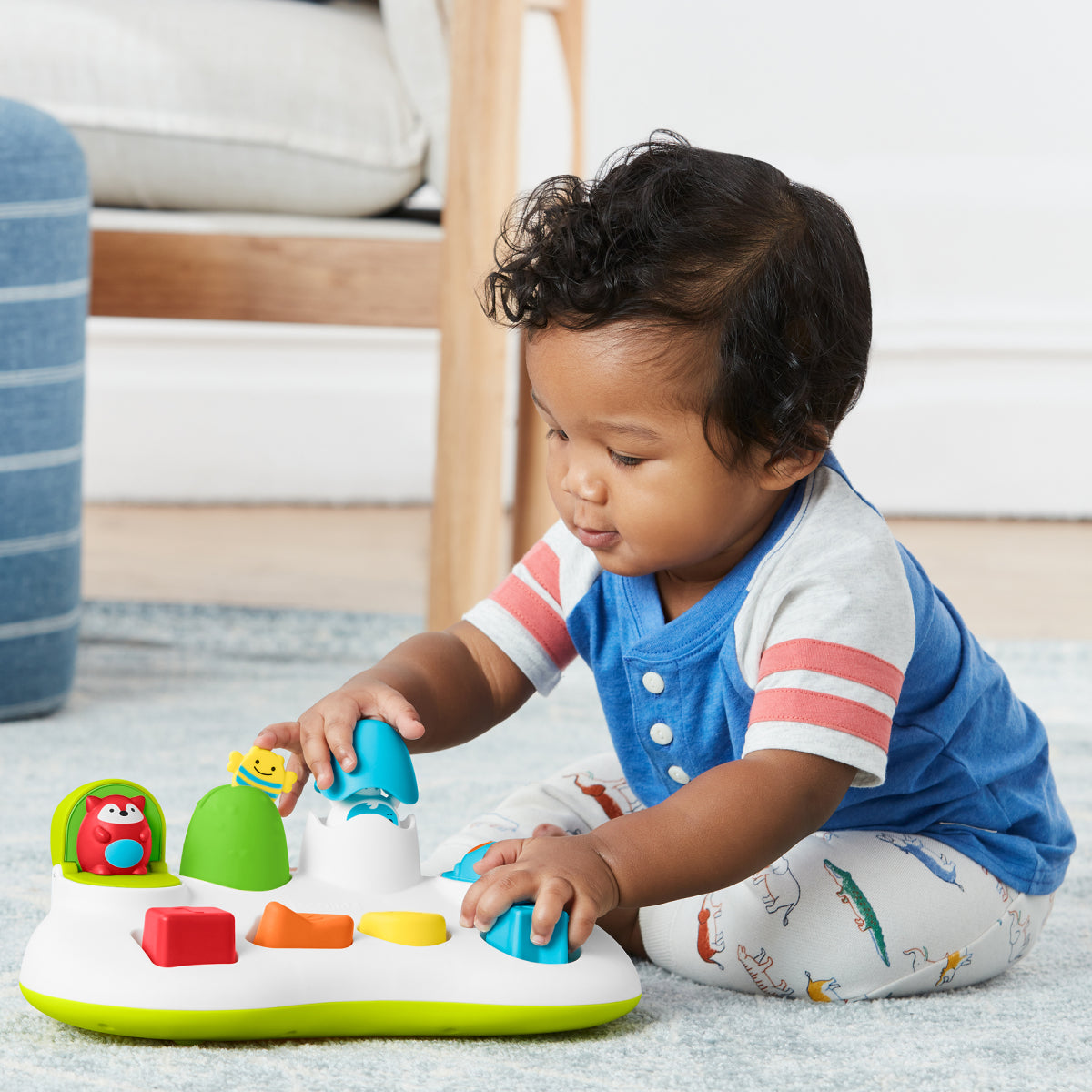 Child playing with a colorful toy on the floor