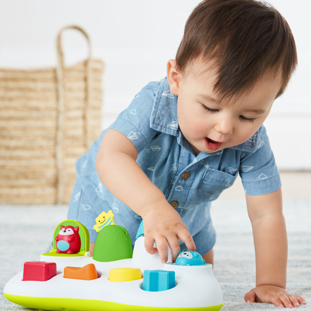 Child playing with a colorful toy on a light surface