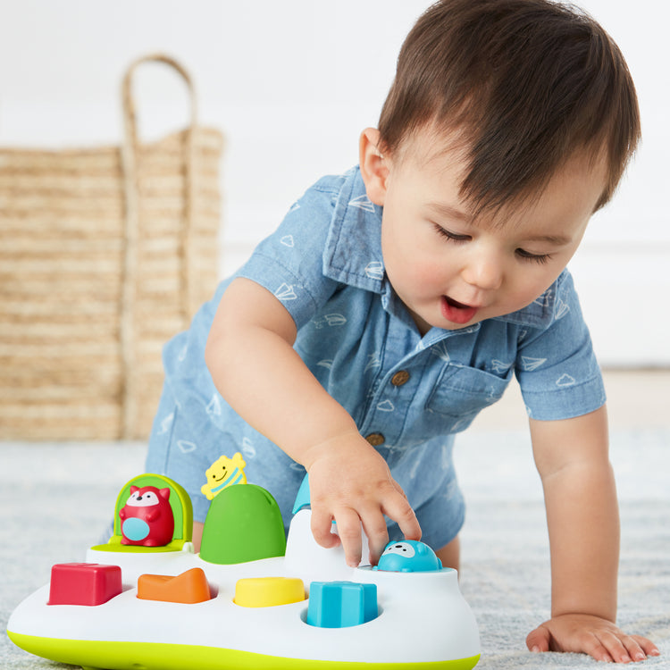 Child playing with a colorful toy on a light surface