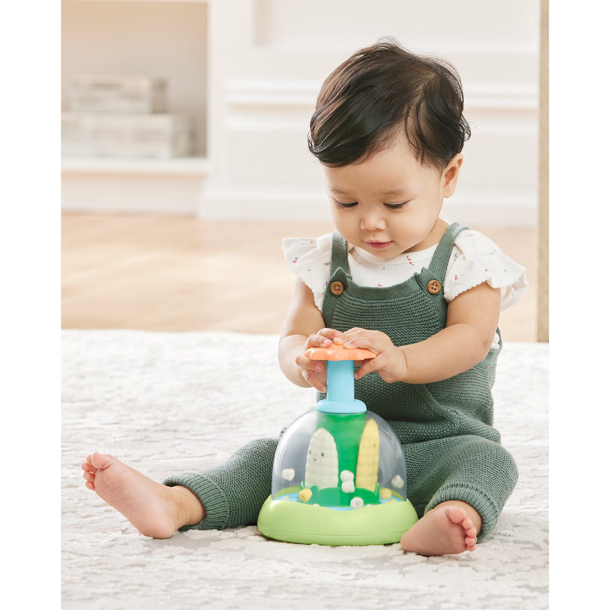 Child playing with a toy on a light-colored rug