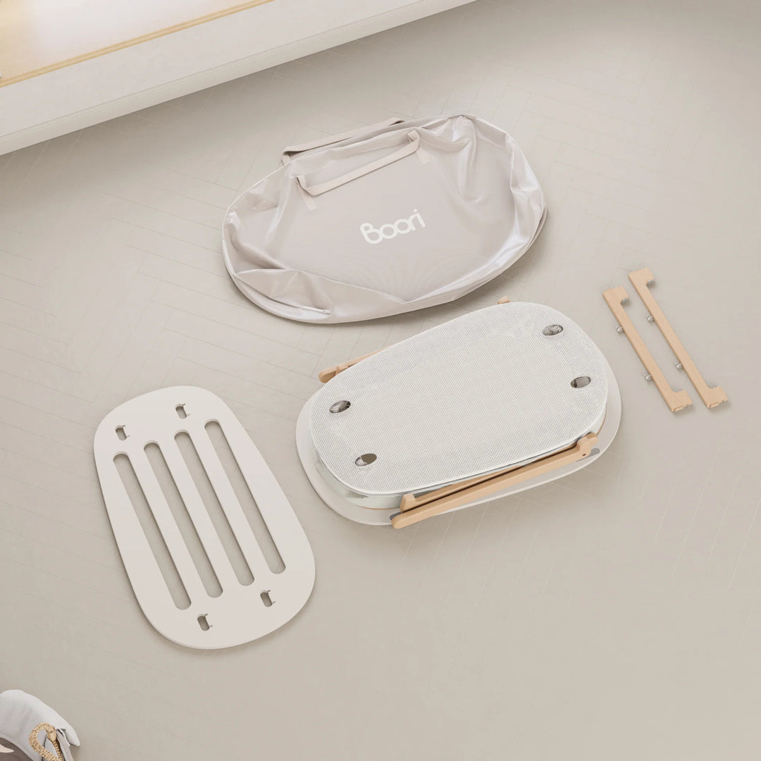 Baby seat parts on a light gray surface with 'Boori' branding.