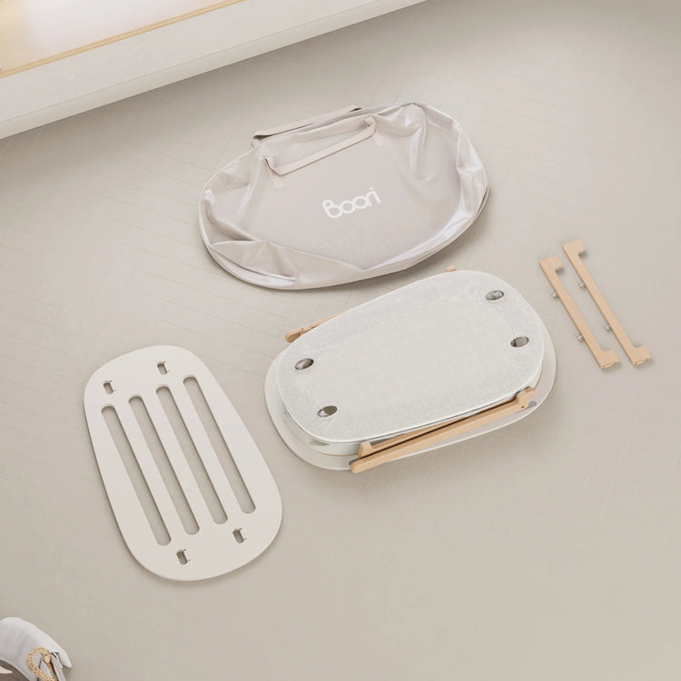 Baby seat parts on a light gray surface with 'Boori' branding.
