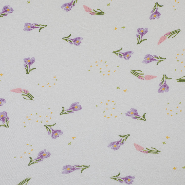 Floral pattern with small purple flowers on a light gray background